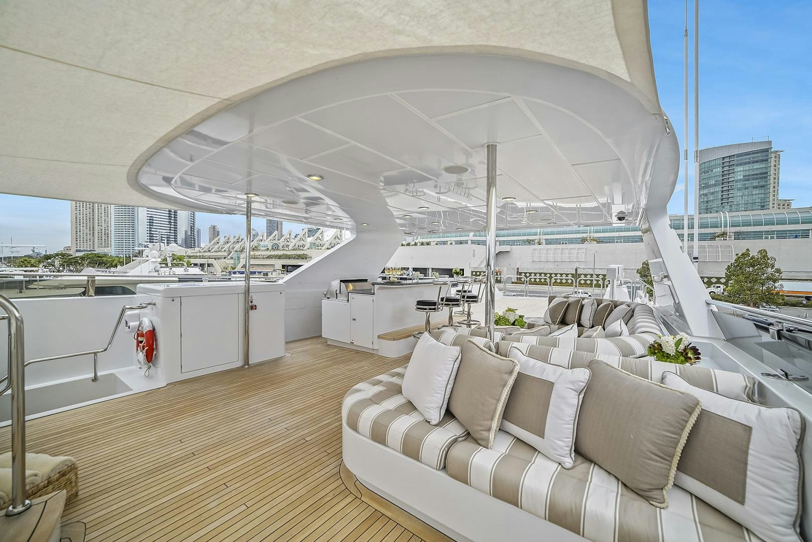 a large white tent with a large white lounge chair and a large white table with chairs and a aboard ARTEMIS Yacht for Sale