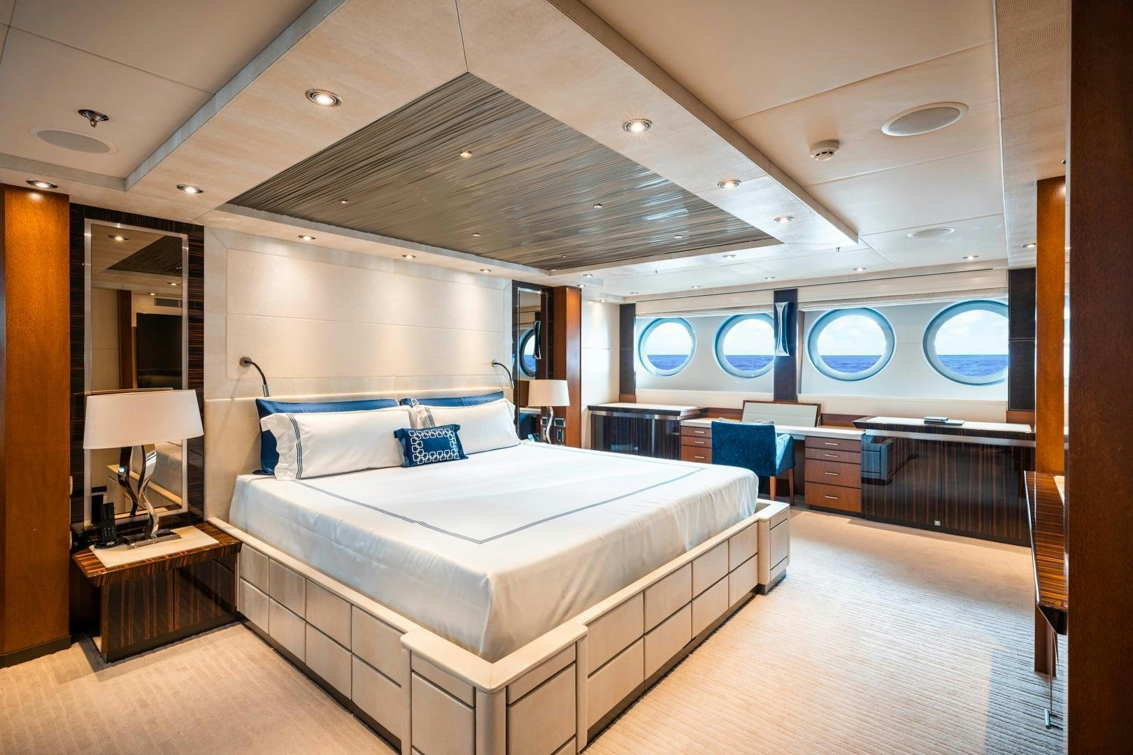 a room with a bed and a large mirror aboard AQUANOVA Yacht for Sale