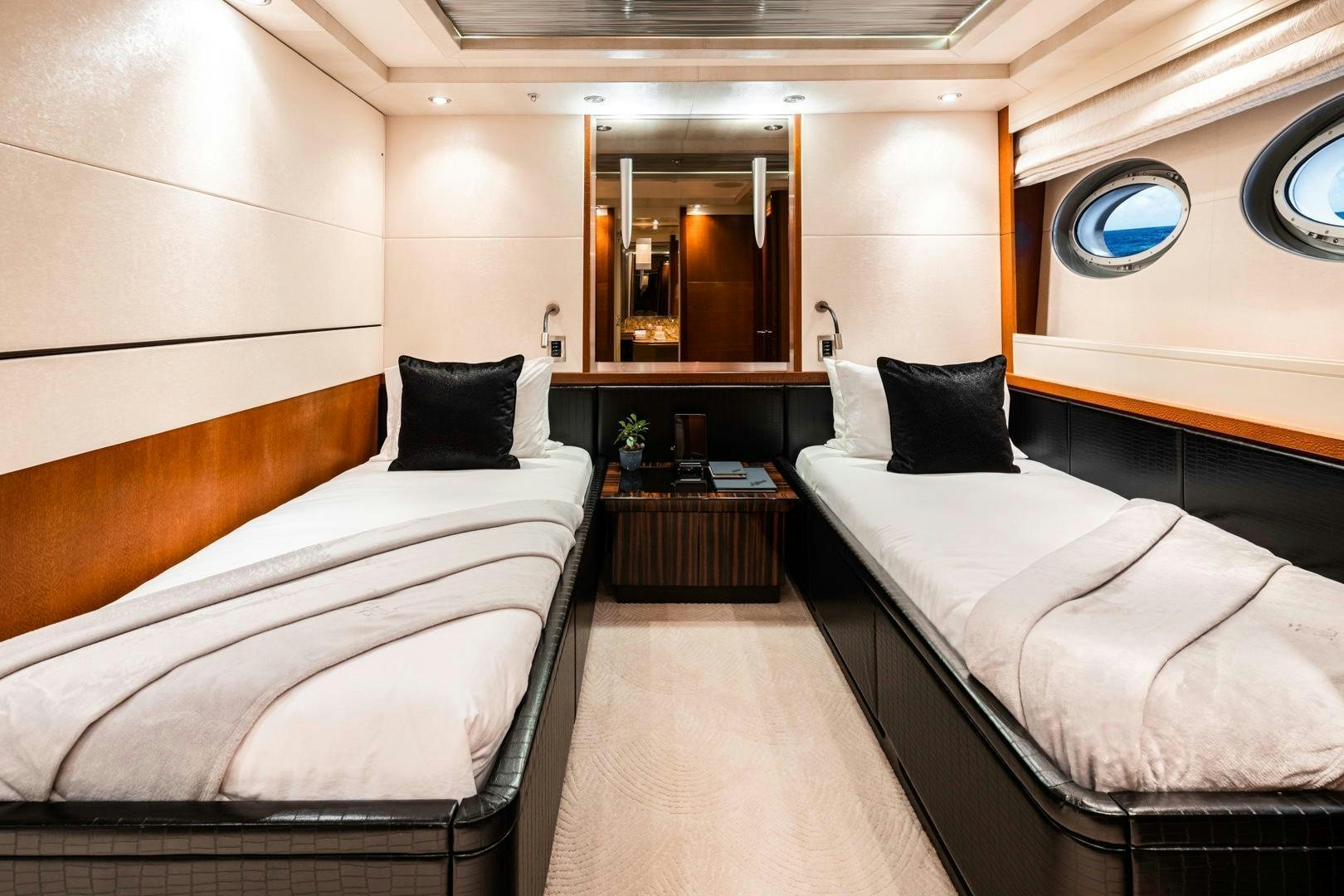 a room with beds and a mirror aboard AQUANOVA Yacht for Sale