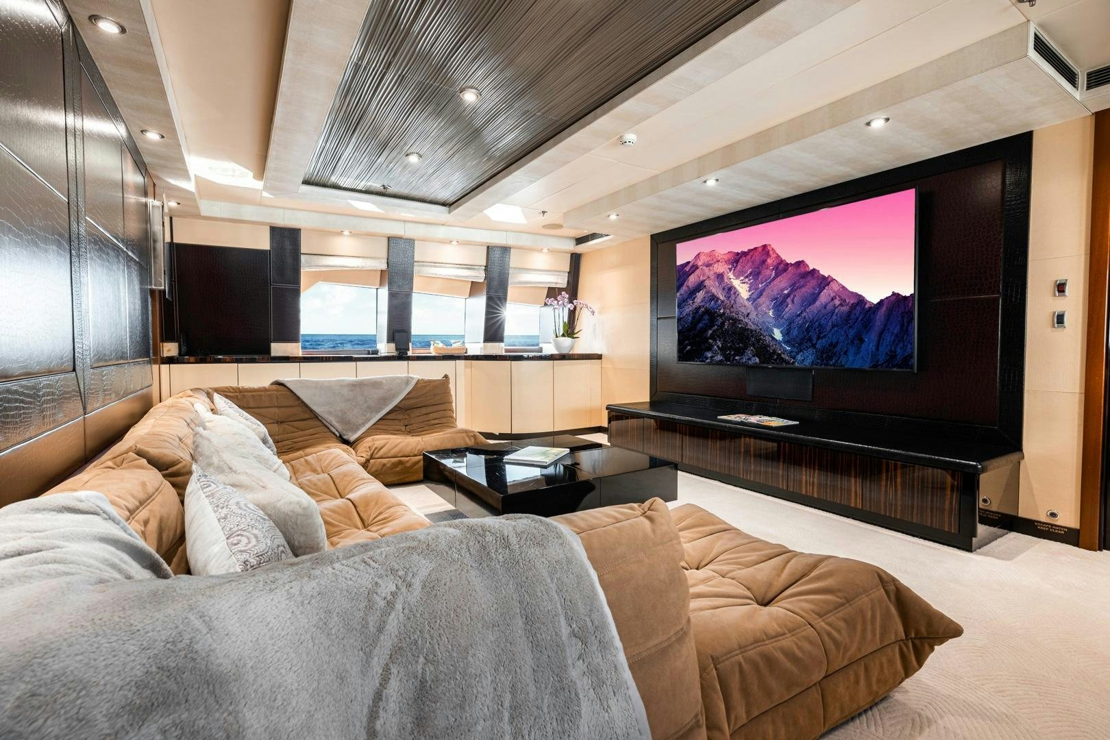 a large living room with a large screen aboard AQUANOVA Yacht for Sale
