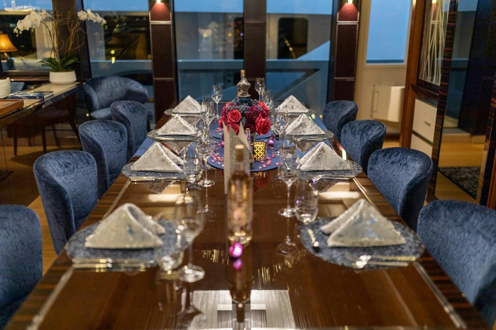 a table with a candle and flowers aboard AQUANOVA Yacht for Sale