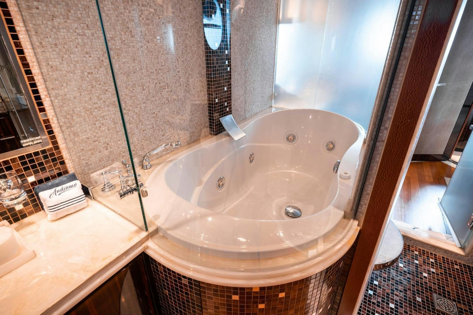 a large white bathtub in a bathroom aboard AQUANOVA Yacht for Sale