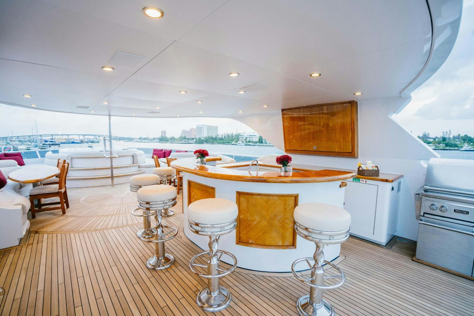 a kitchen with white cabinets and a table with chairs aboard EXCELLENCE Yacht for Sale