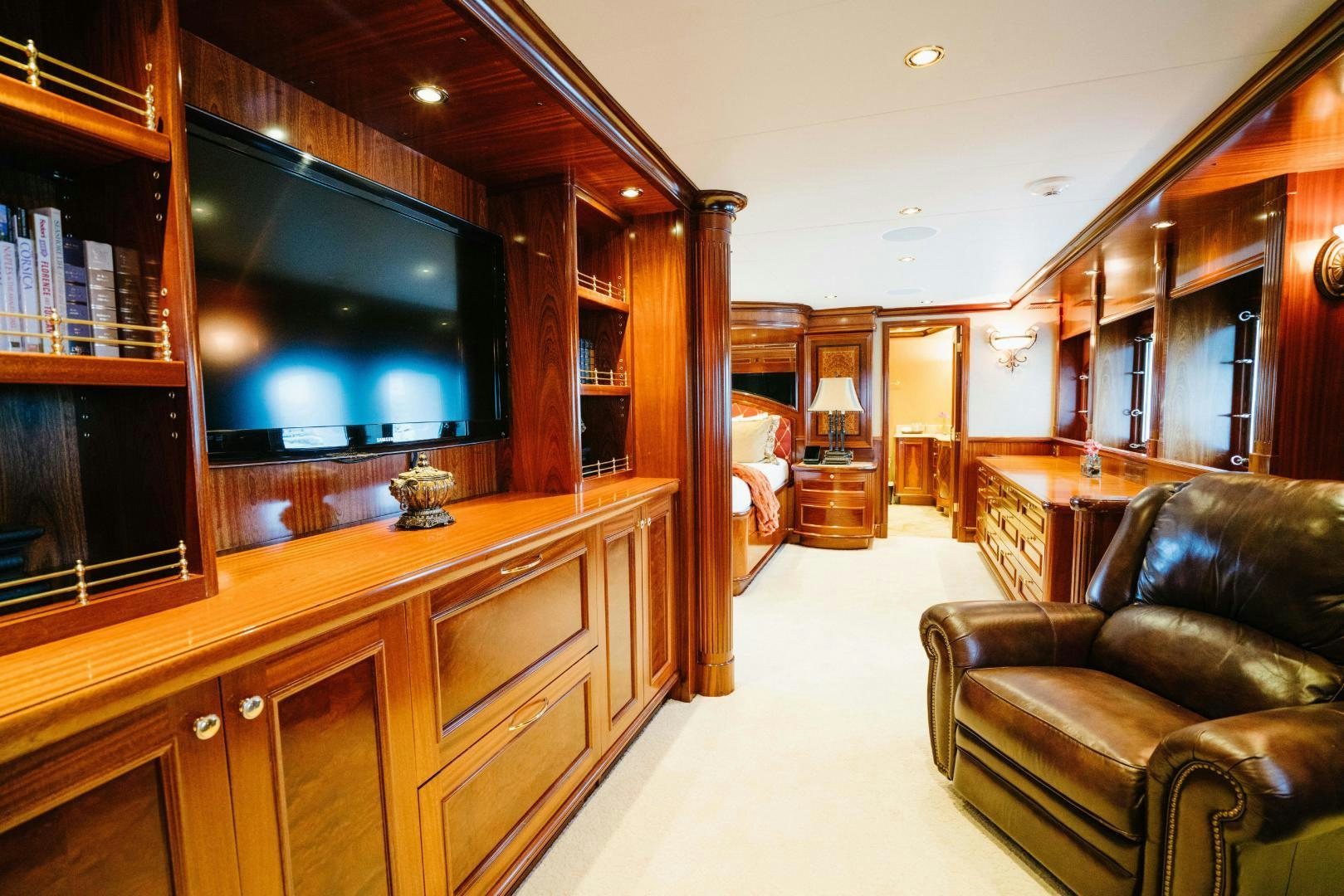 a living room with a leather couch aboard EXCELLENCE Yacht for Sale