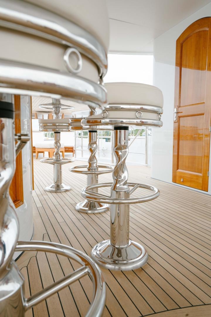 a glass table with a few glasses on it aboard EXCELLENCE Yacht for Sale