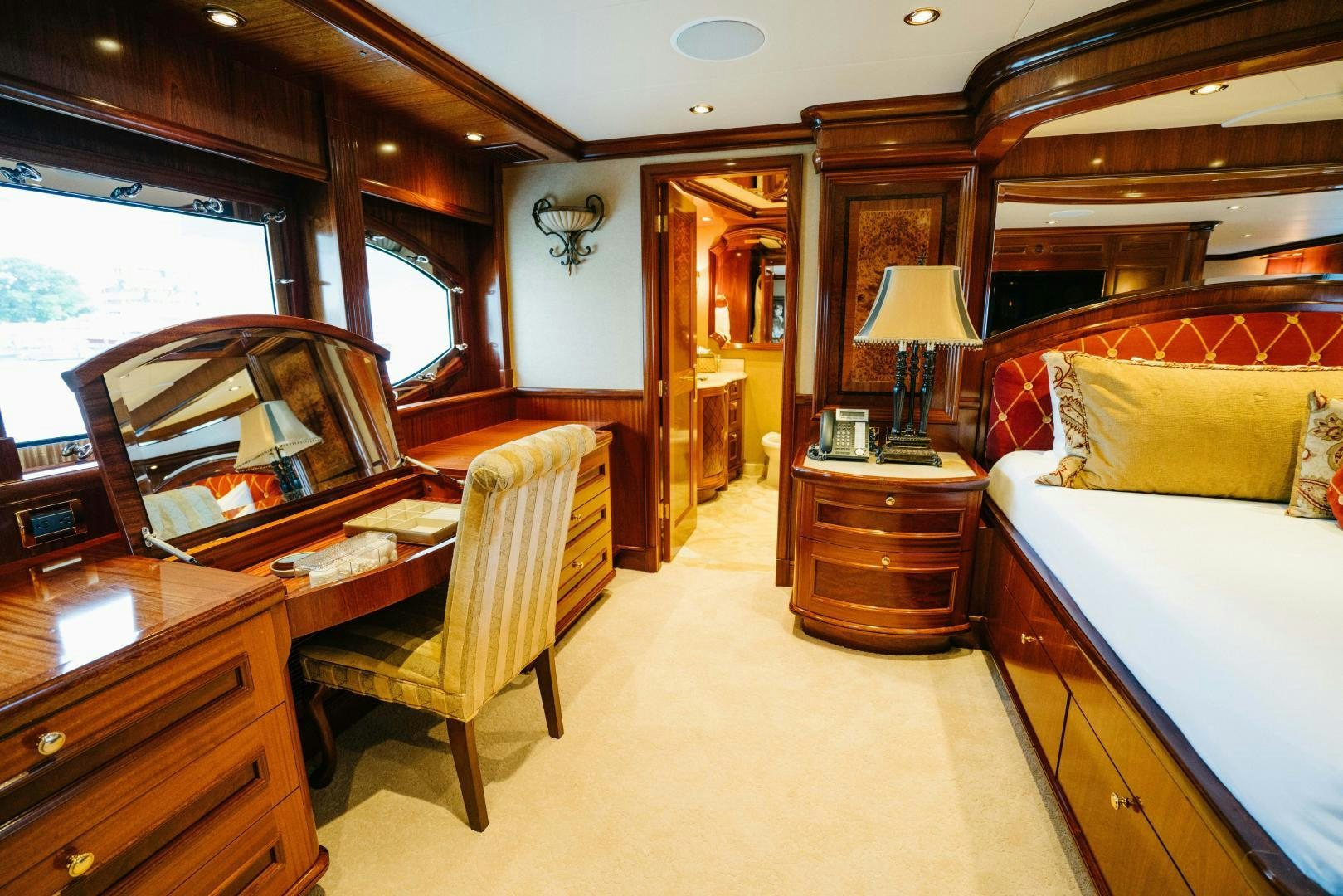 a bedroom with a bed desk and a chair aboard EXCELLENCE Yacht for Sale
