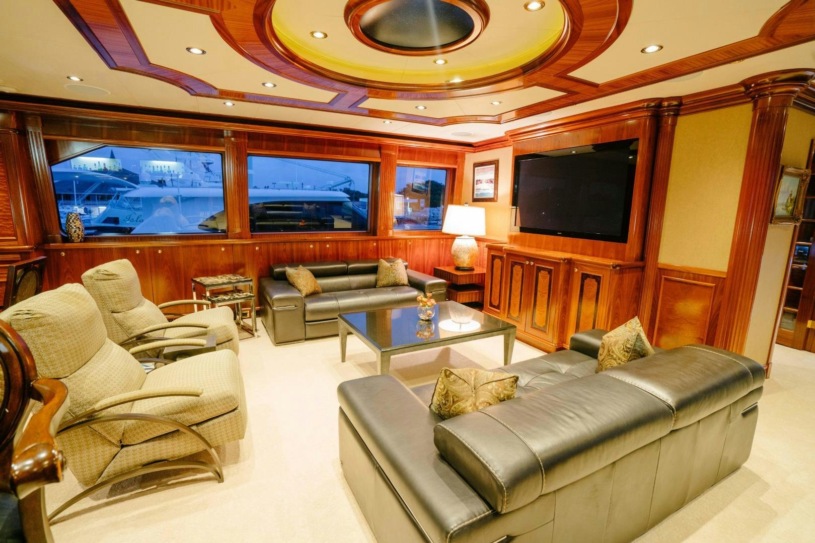 a living room with a large screen aboard EXCELLENCE Yacht for Sale