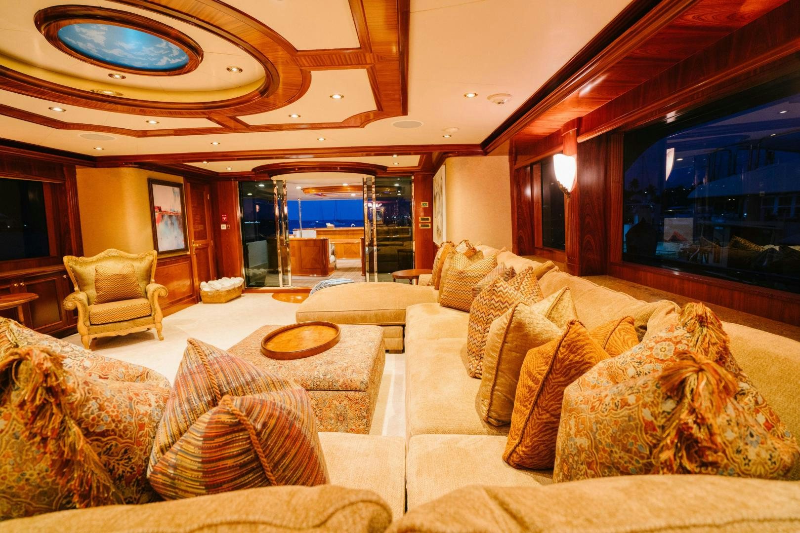 a living room with a large fireplace aboard EXCELLENCE Yacht for Sale