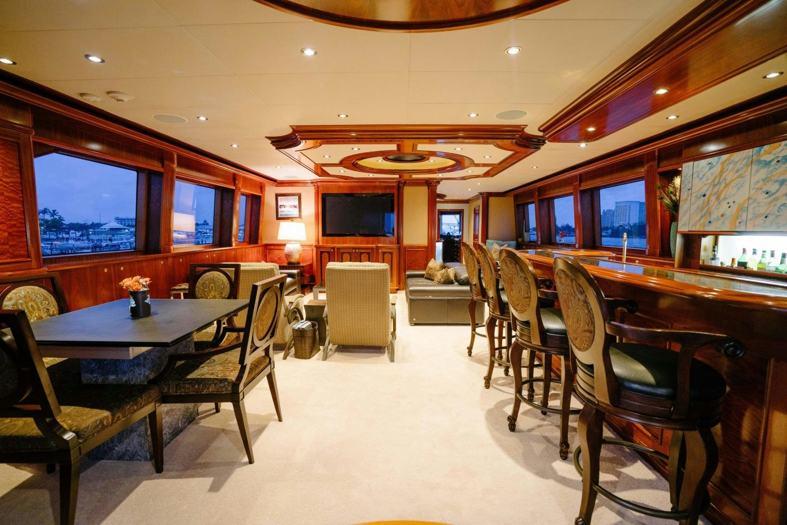 a room with tables and chairs aboard EXCELLENCE Yacht for Sale