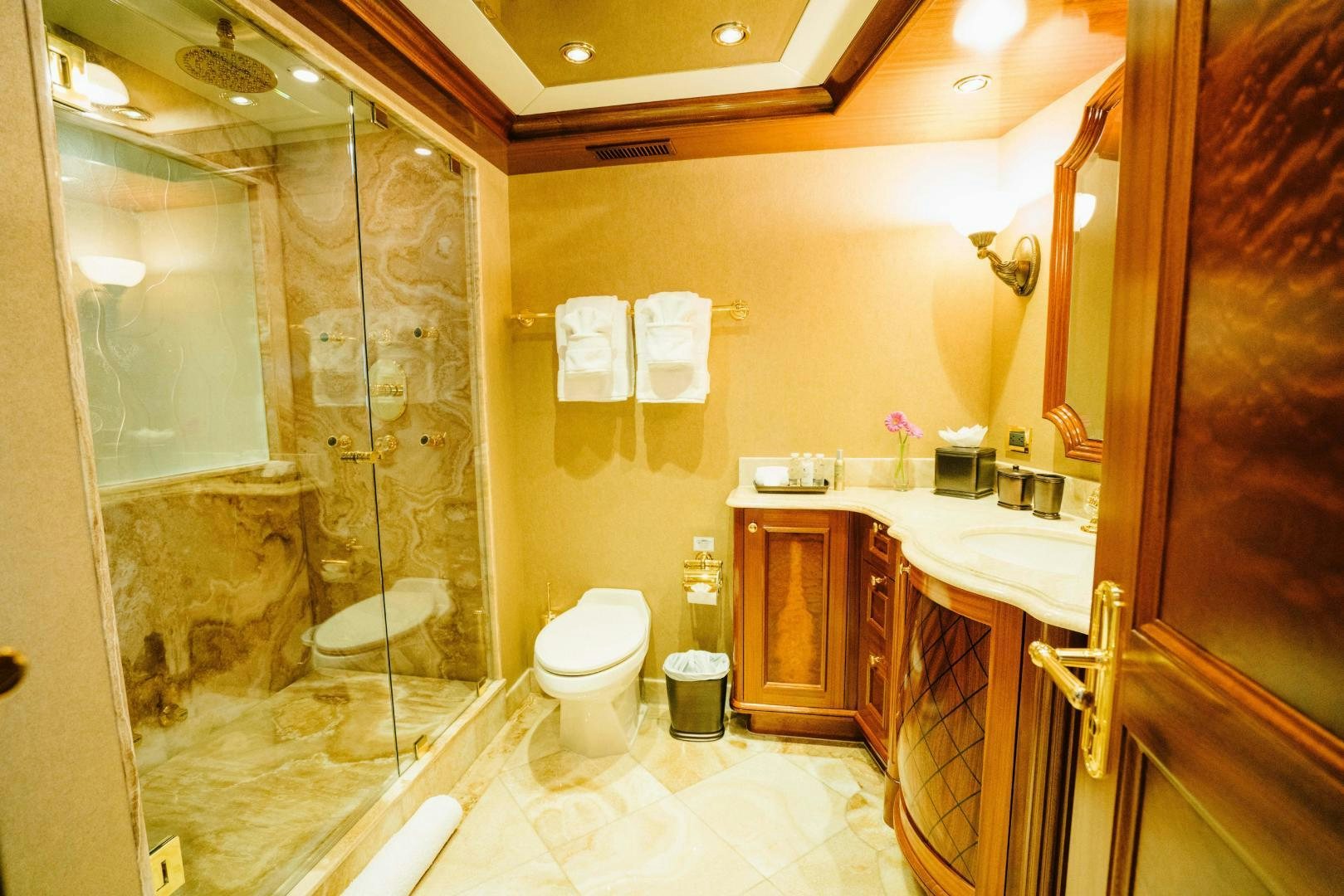 a bathroom with a glass shower aboard EXCELLENCE Yacht for Sale