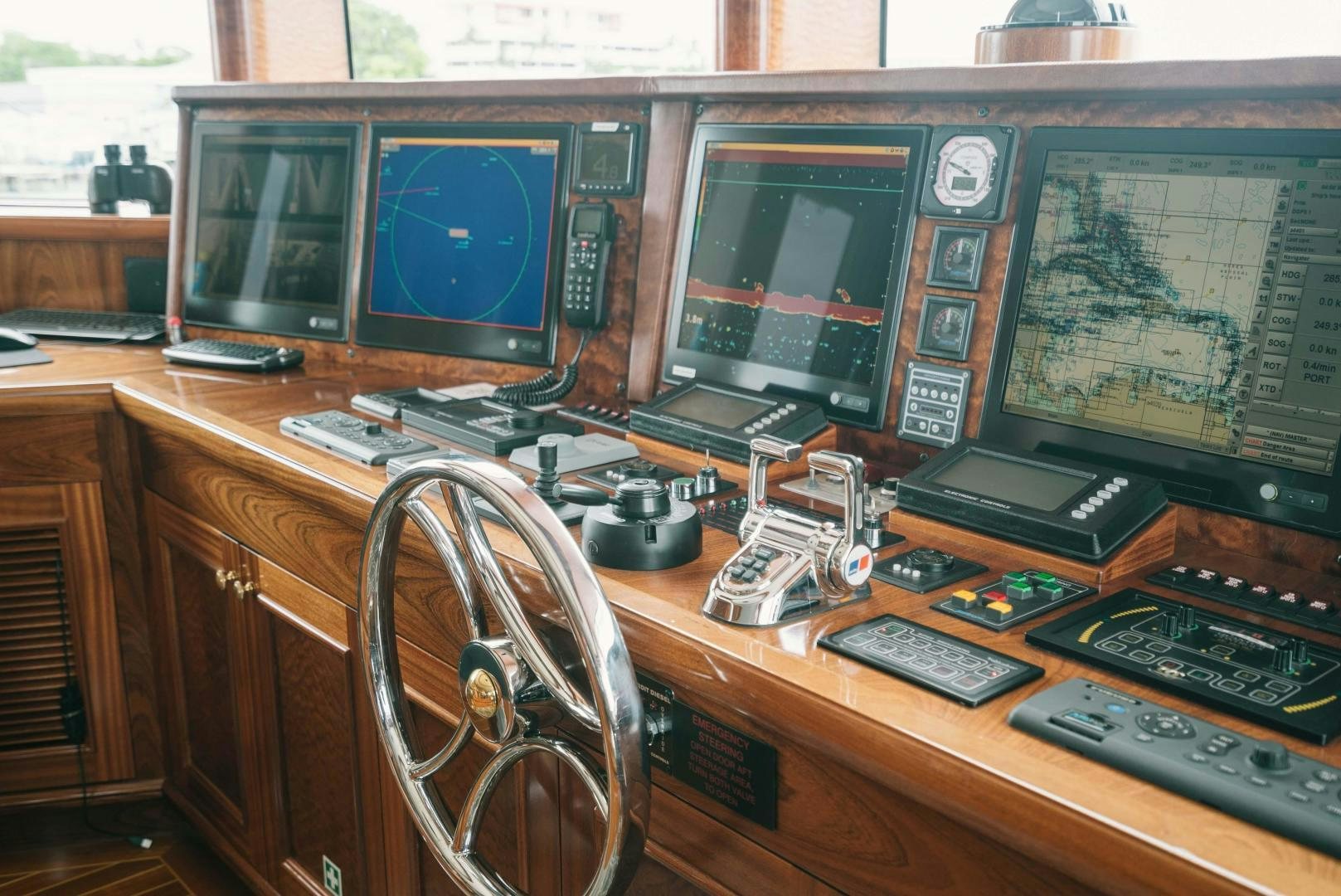 a desk with a computer and other electronic devices on it aboard EXCELLENCE Yacht for Sale