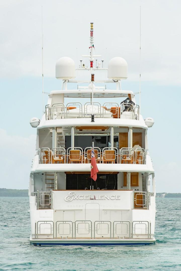 a large white boat with a red flag on it aboard EXCELLENCE Yacht for Sale
