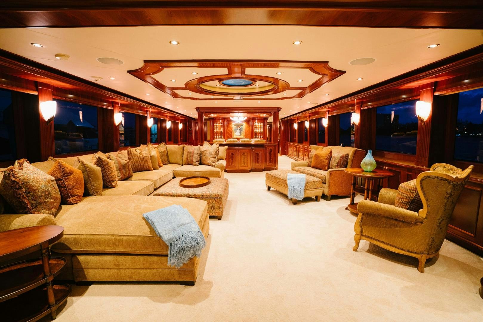 a large living room with a chandelier aboard EXCELLENCE Yacht for Sale