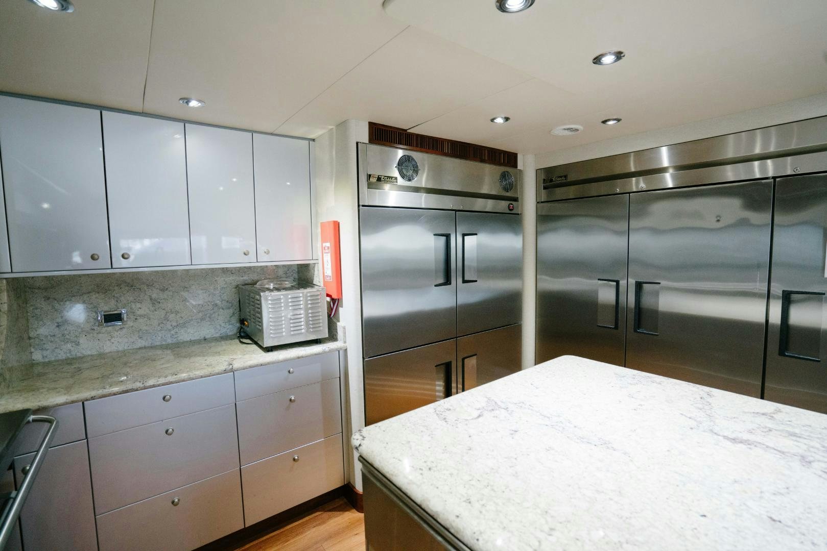 a kitchen with a large island aboard EXCELLENCE Yacht for Sale