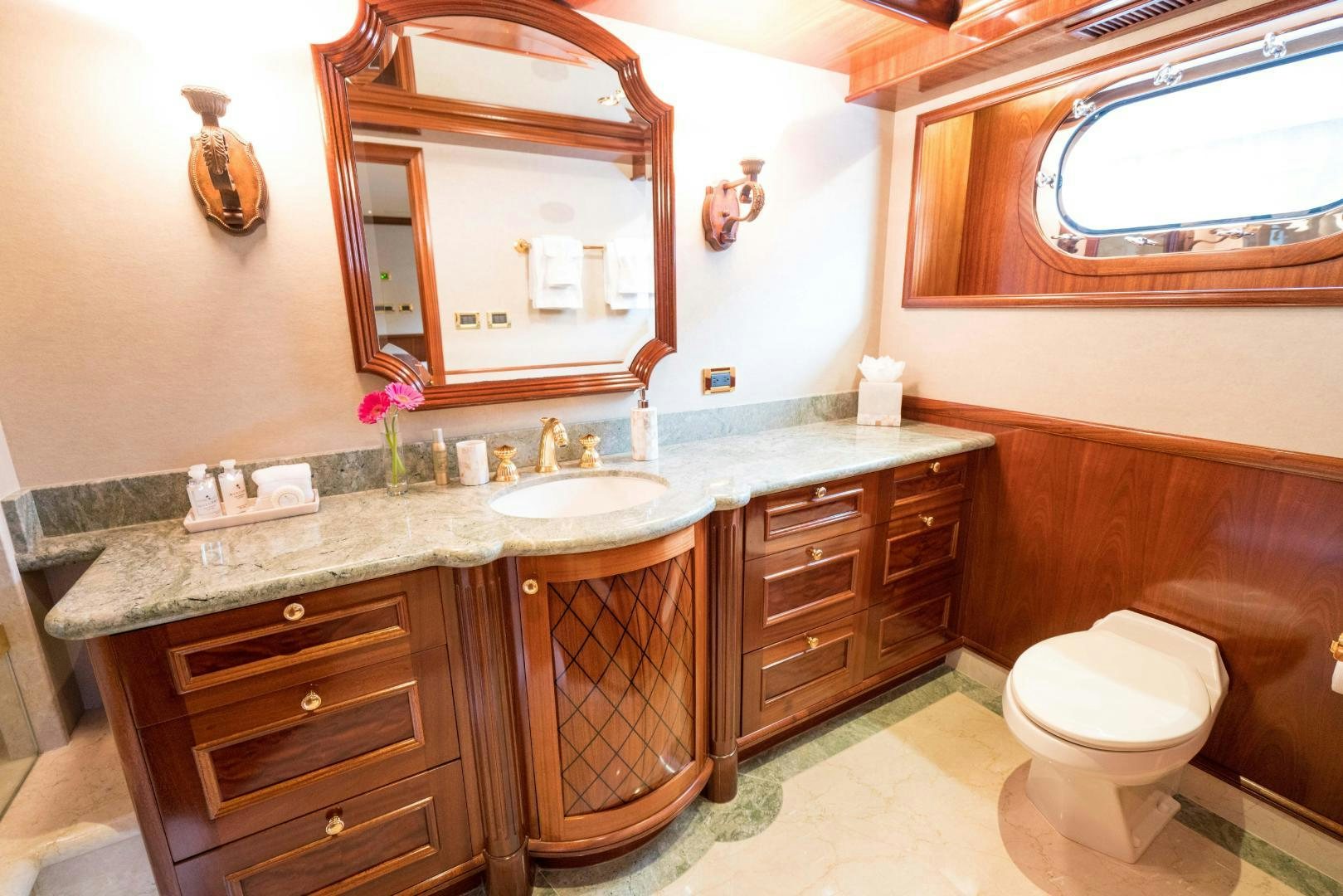 a bathroom with a large mirror aboard EXCELLENCE Yacht for Sale