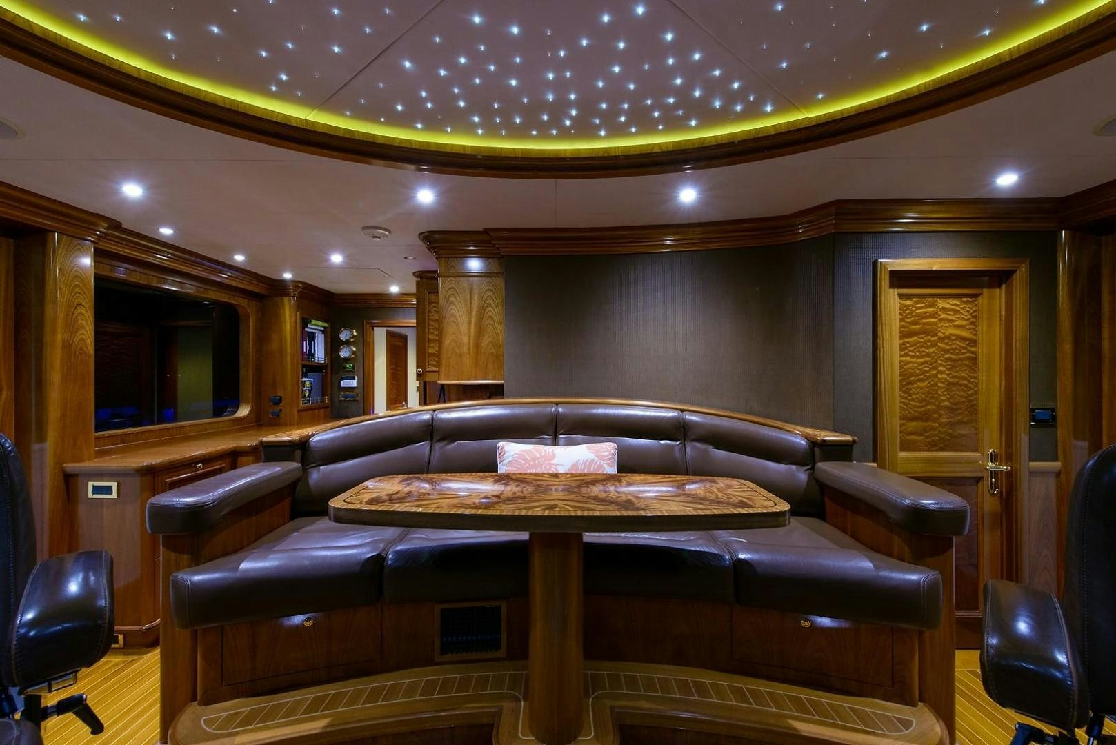 a living room with a leather couch aboard EXCELLENCE Yacht for Sale