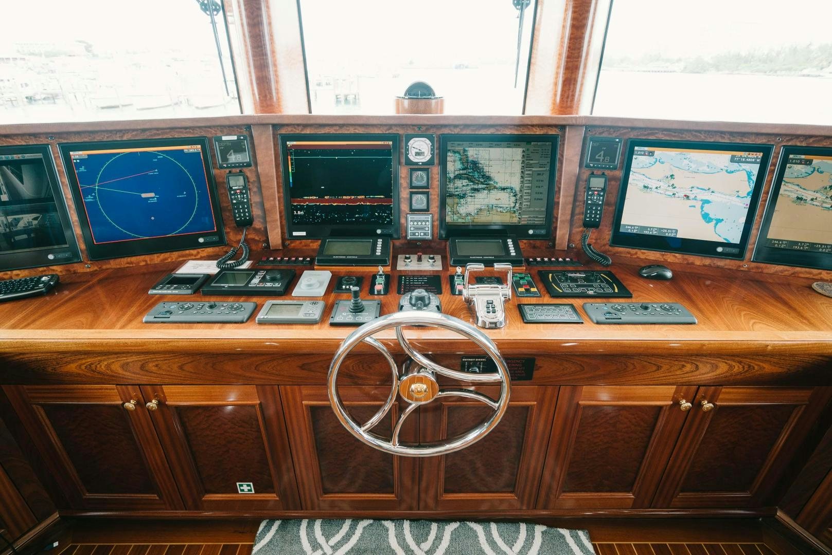 a desk with many electronic devices aboard EXCELLENCE Yacht for Sale