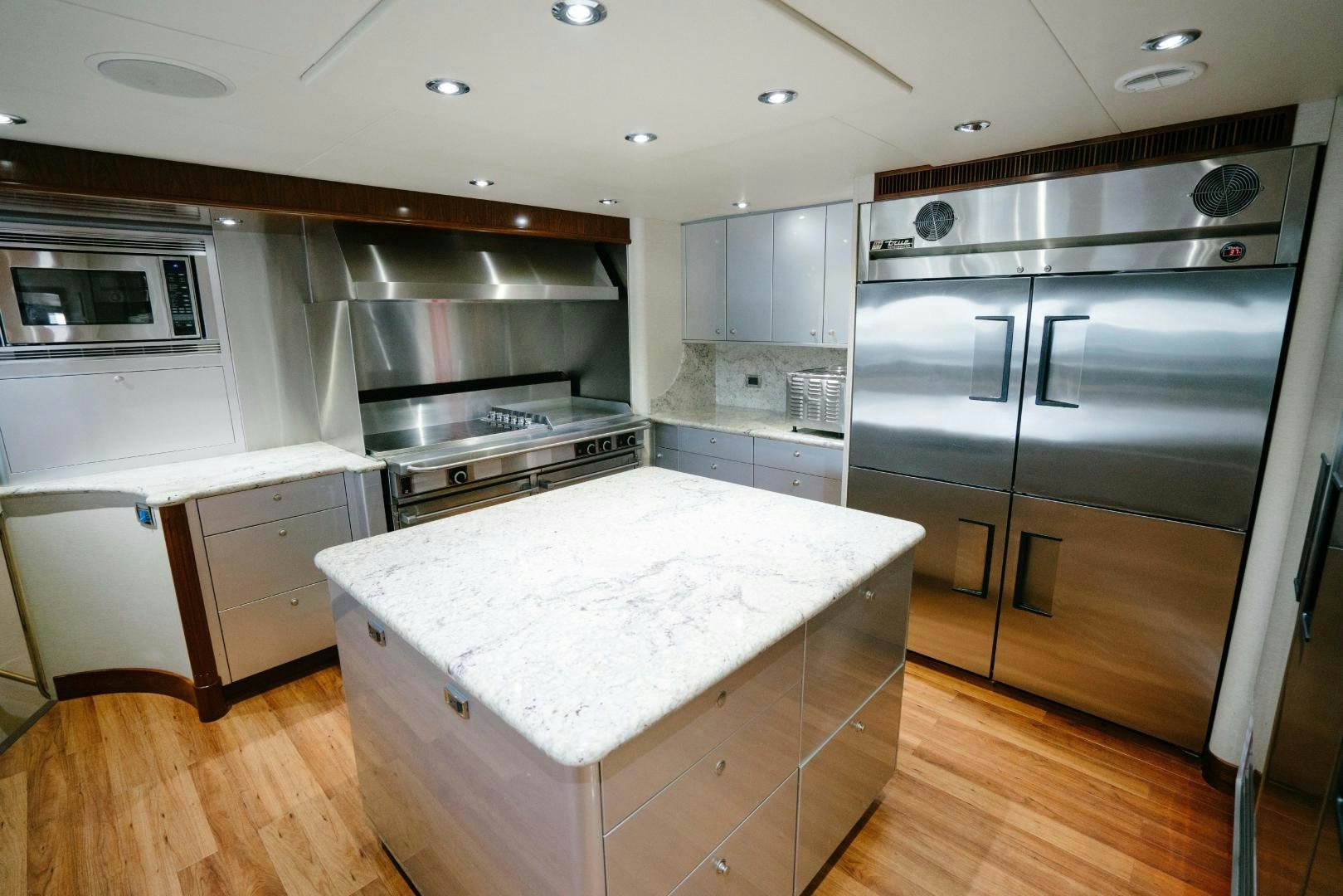 a large kitchen with a large island aboard EXCELLENCE Yacht for Sale