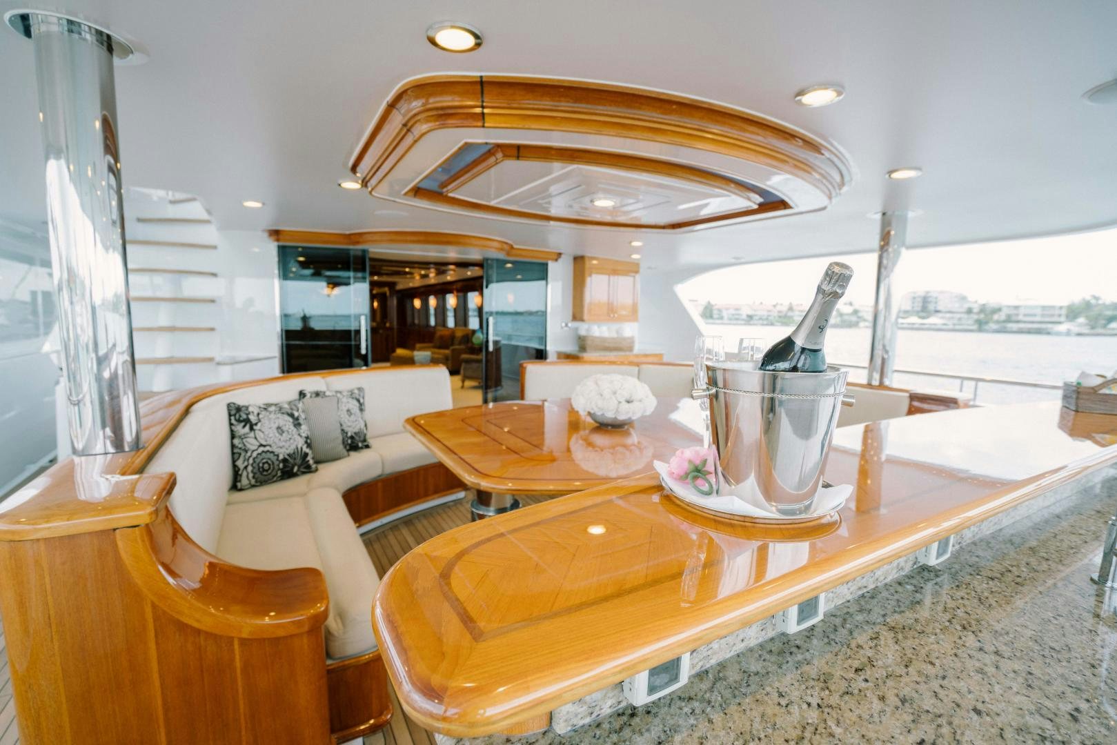 a living room with a large glass table and a large window aboard EXCELLENCE Yacht for Sale