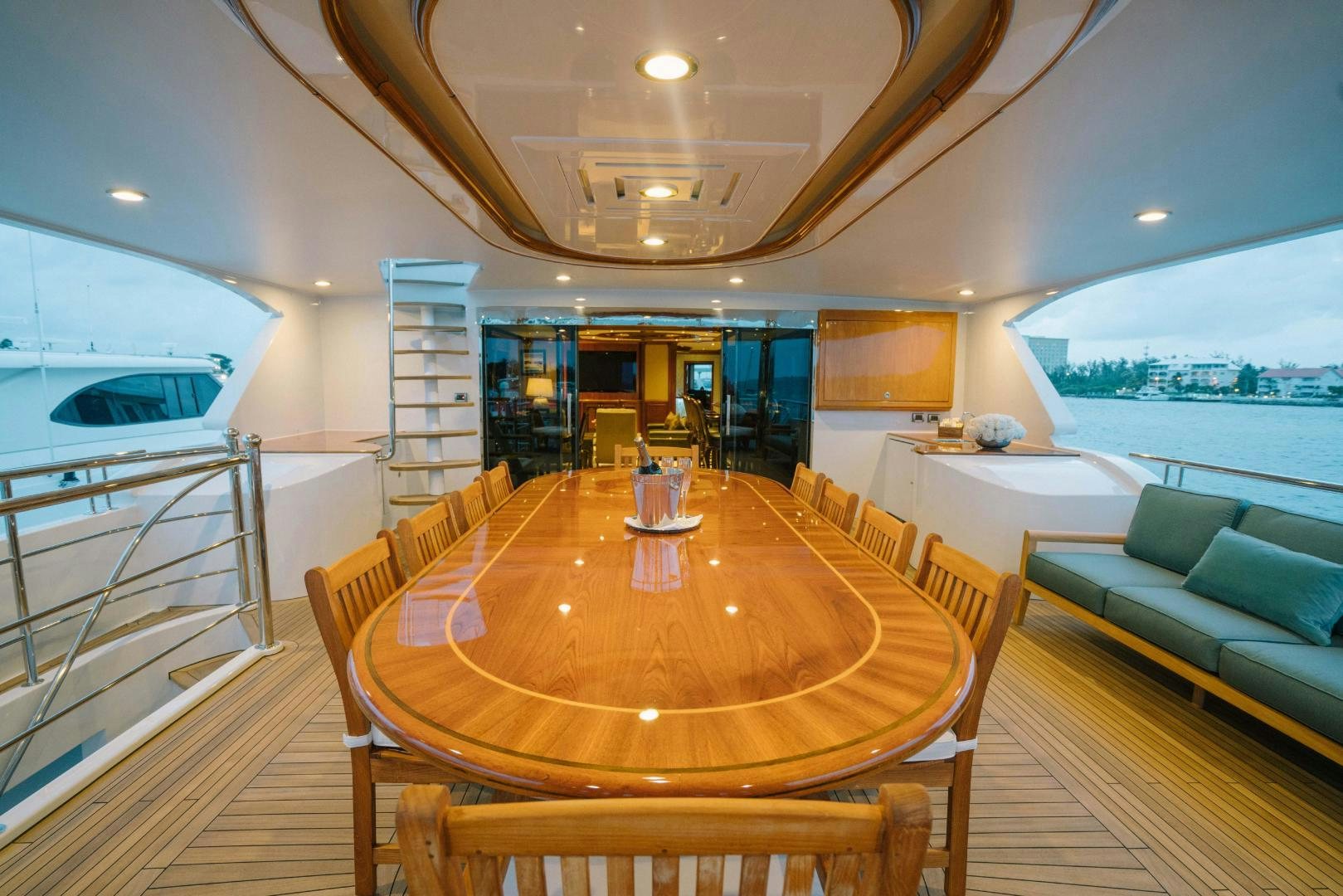 a living room with a table and couches aboard EXCELLENCE Yacht for Sale