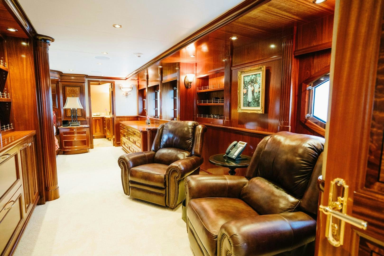 a living room with leather furniture aboard EXCELLENCE Yacht for Sale