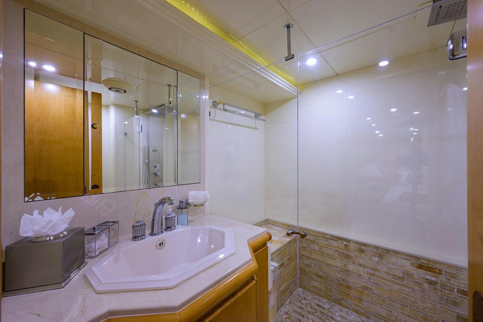 a bathroom with a large mirror aboard CABERNET Yacht for Sale