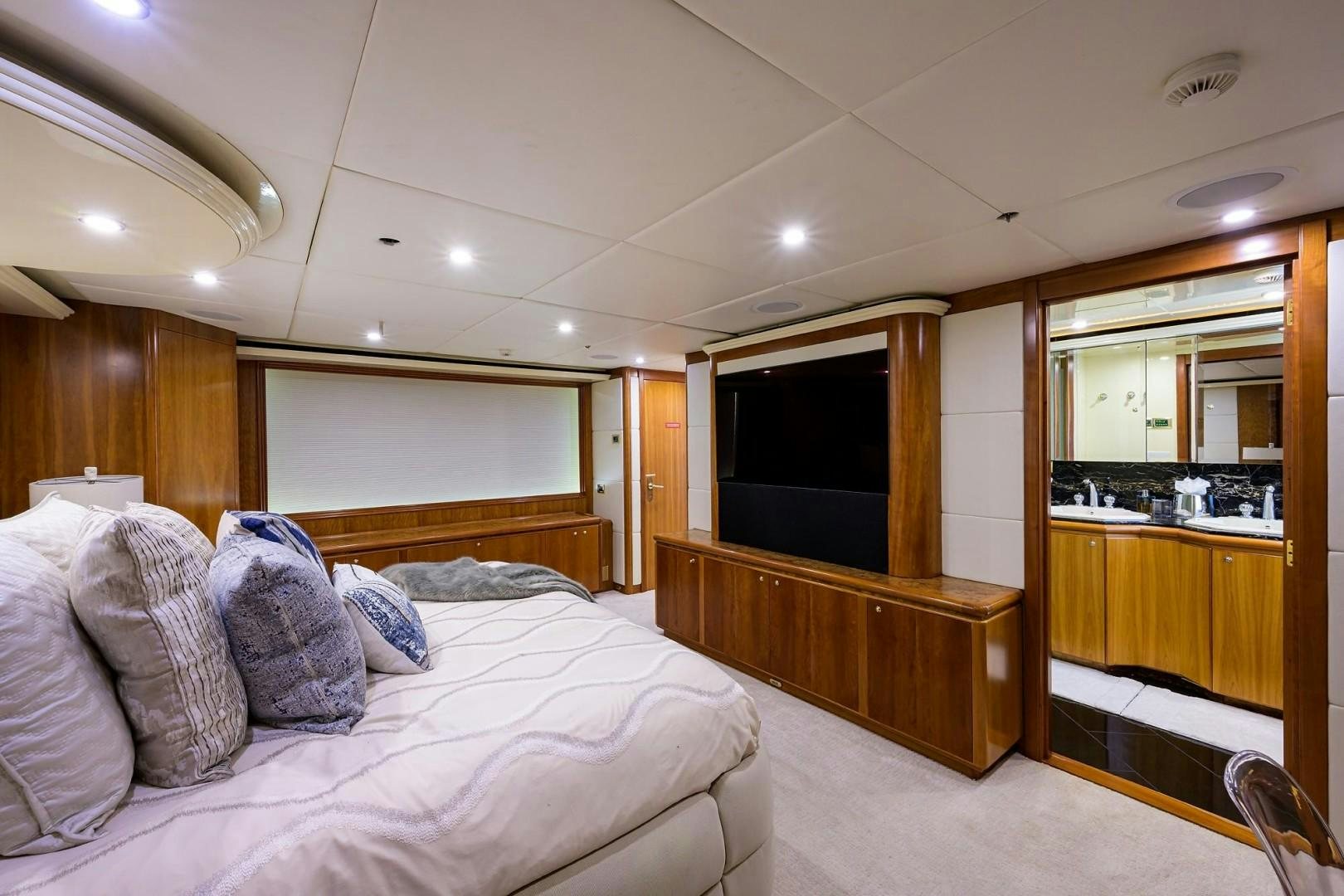 a bedroom with a bed and a tv aboard CABERNET Yacht for Sale