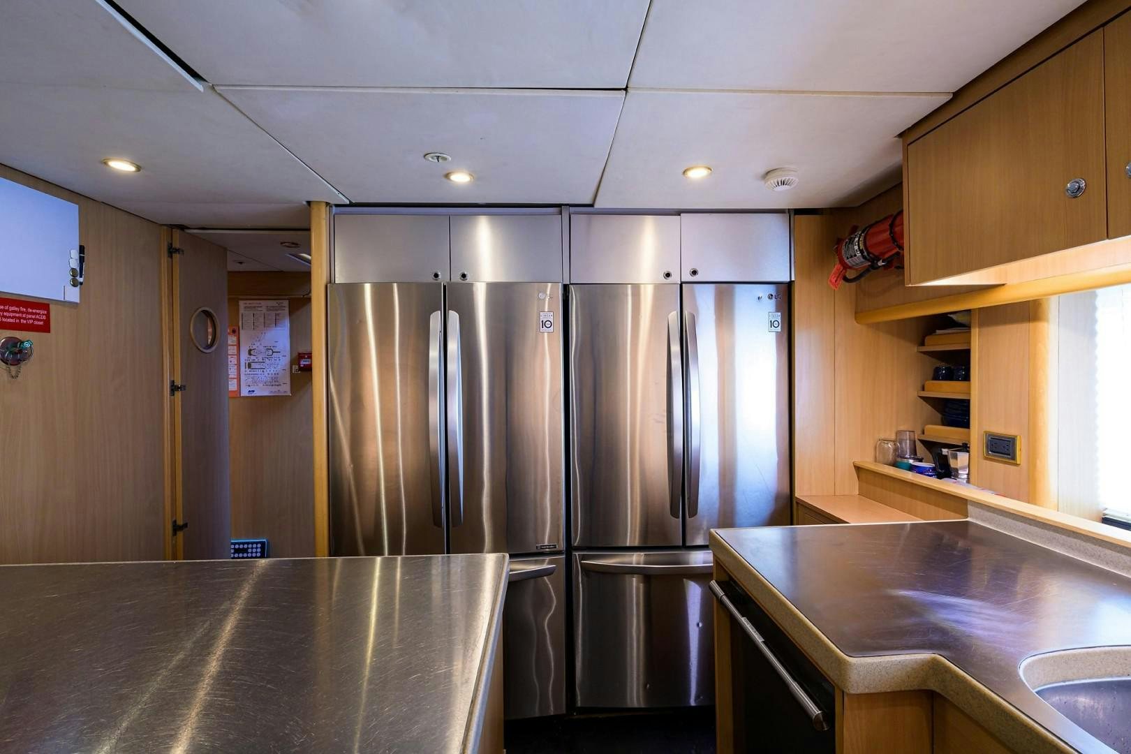 a kitchen with stainless steel refrigerators aboard CABERNET Yacht for Sale