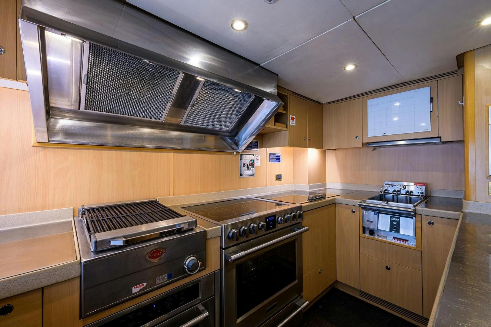 a kitchen with wooden cabinets aboard CABERNET Yacht for Sale