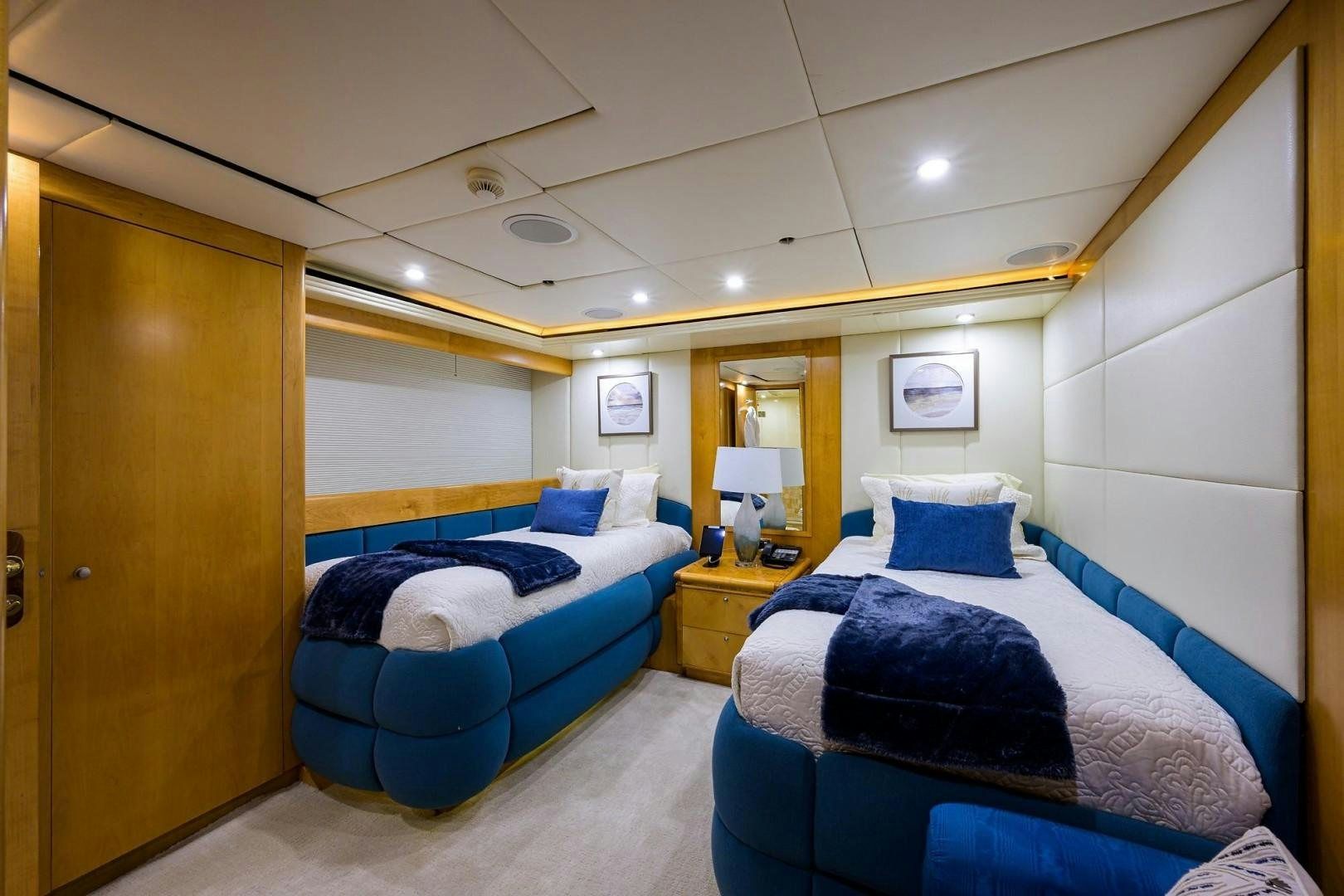 a room with blue beds aboard CABERNET Yacht for Sale