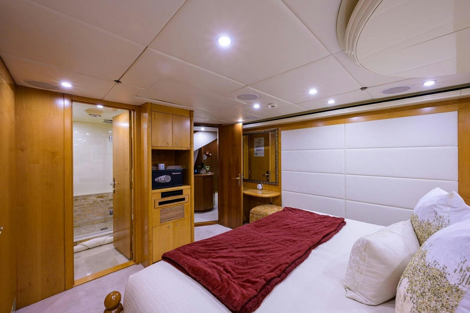 a bedroom with a bed and a mirror aboard CABERNET Yacht for Sale
