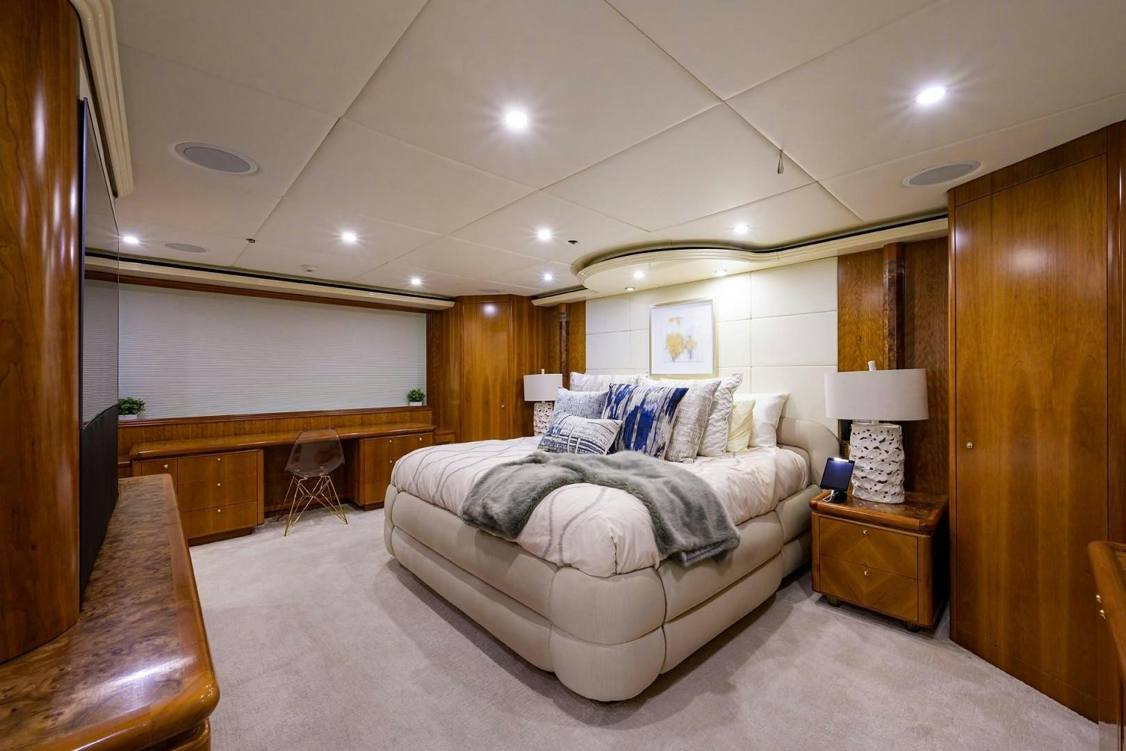 a bedroom with a bed and a desk aboard CABERNET Yacht for Sale