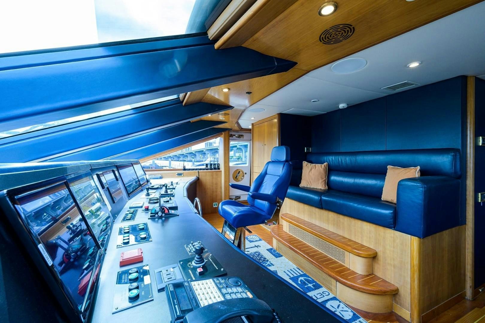 a room with a couch and a table with a computer on it aboard CABERNET Yacht for Sale
