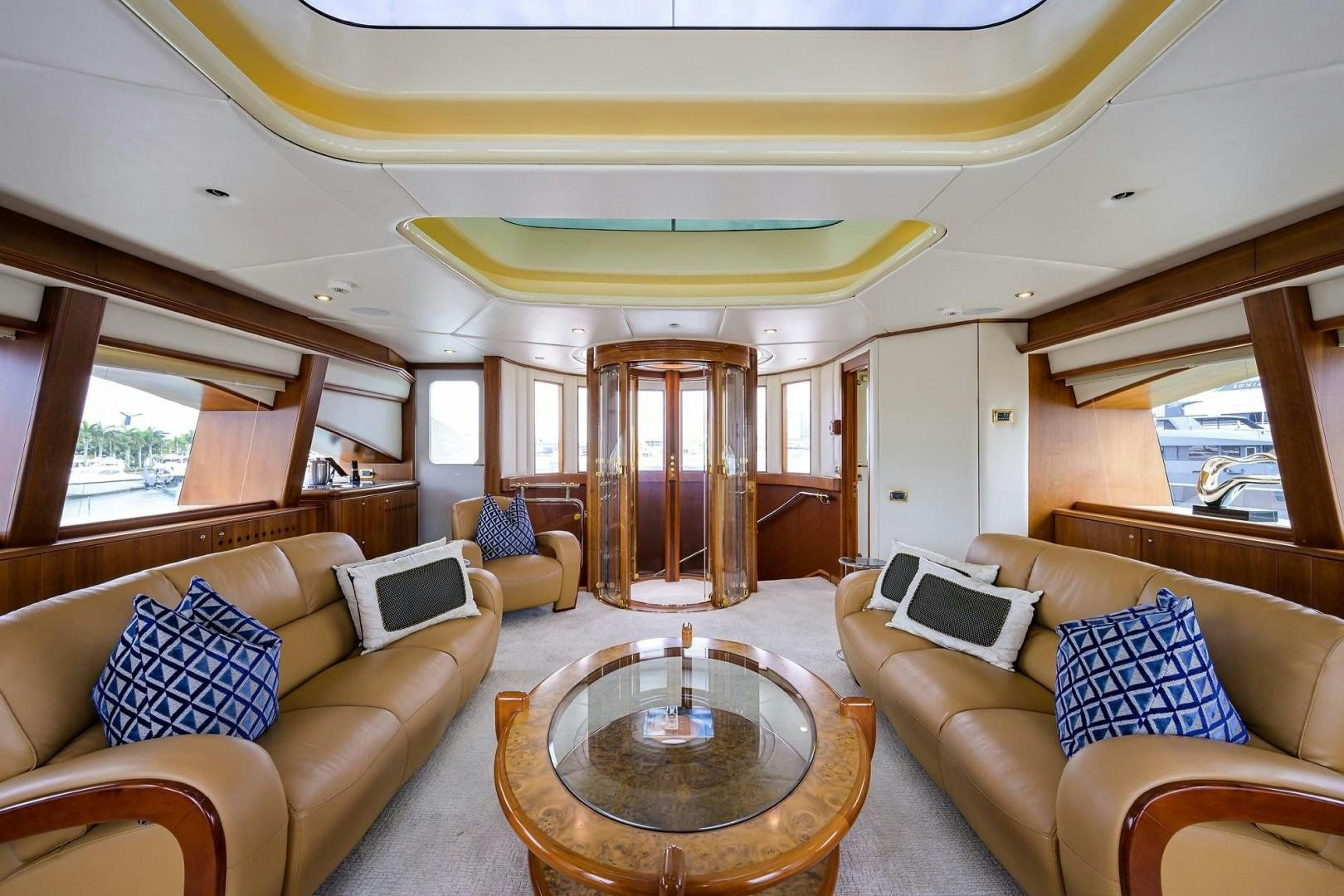 a living room with a table and couches aboard CABERNET Yacht for Sale