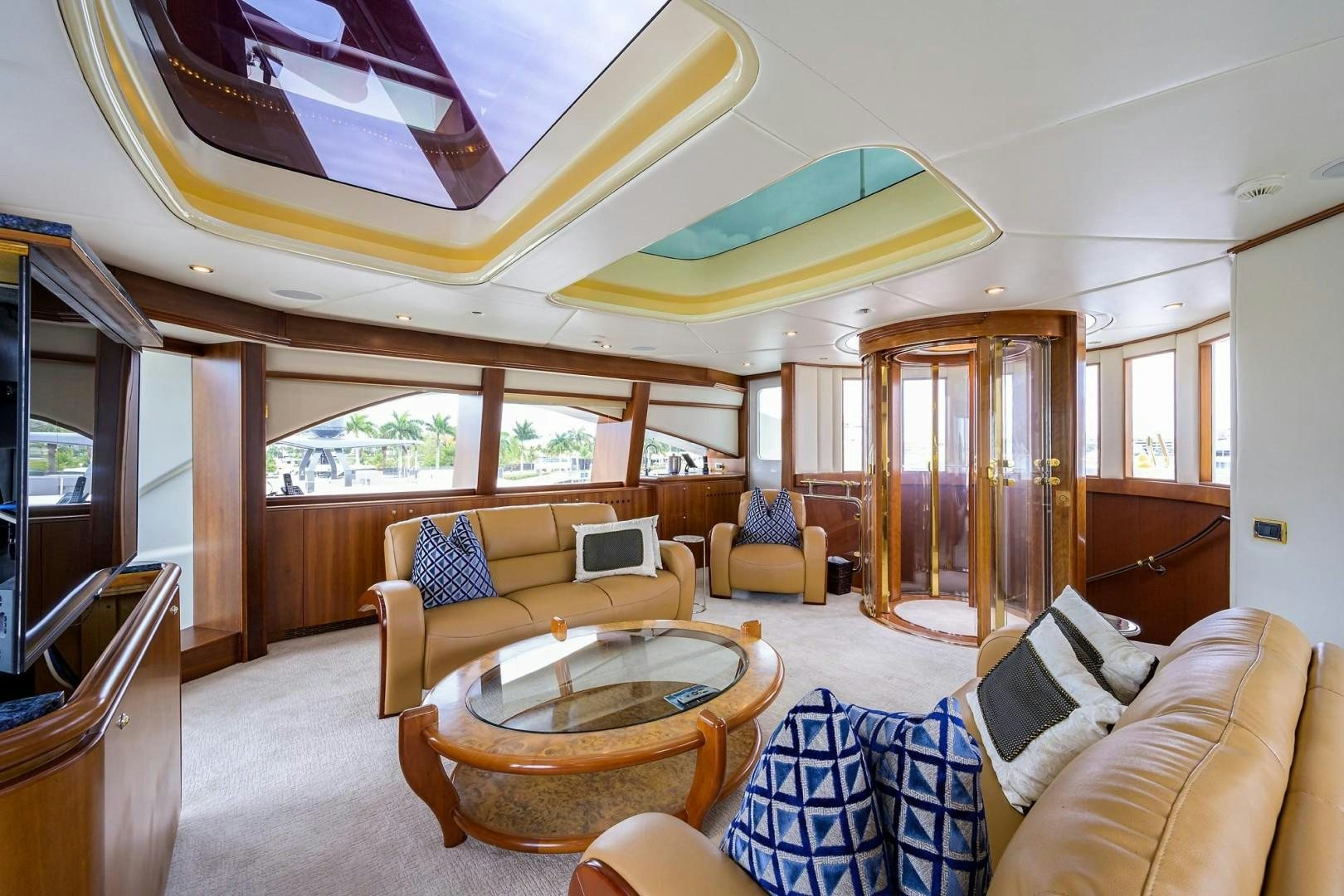 a living room with a table and chairs aboard CABERNET Yacht for Sale