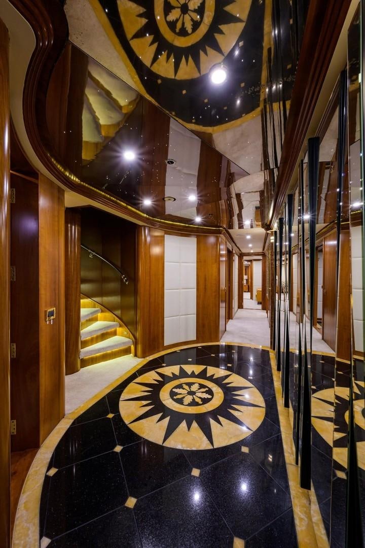 a staircase with a chandelier aboard CABERNET Yacht for Sale