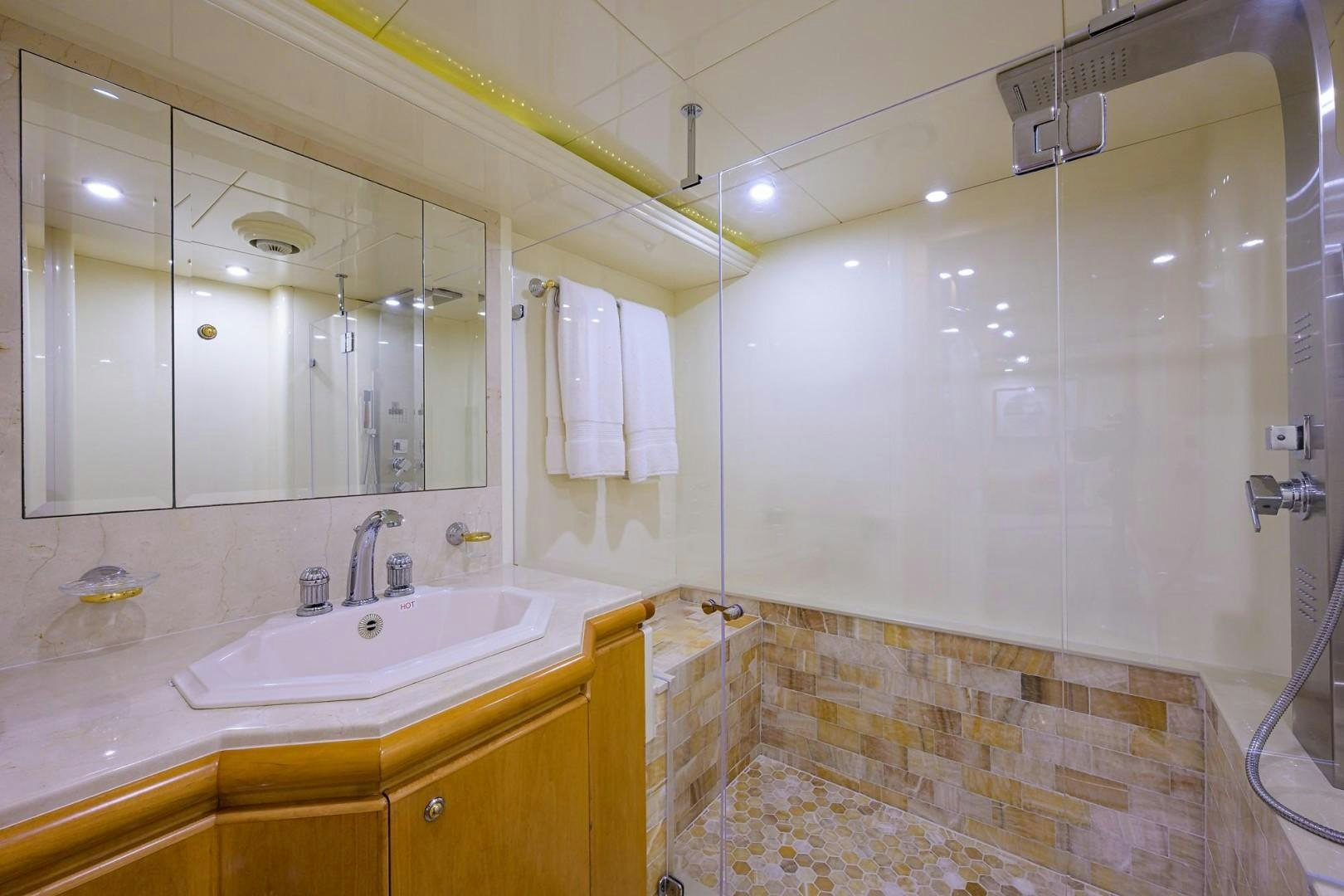 a bathroom with a shower and sink aboard CABERNET Yacht for Sale
