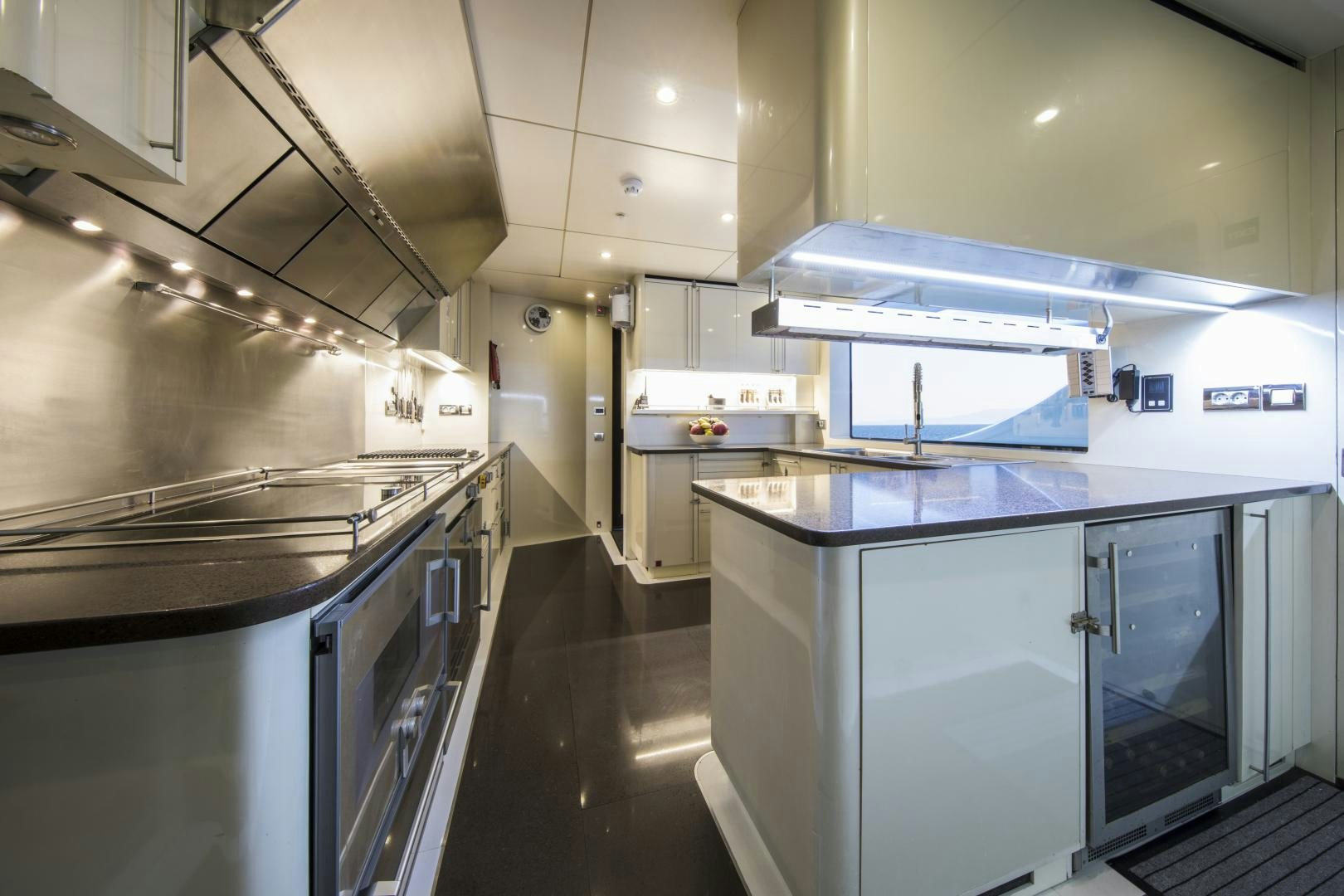 a kitchen with white cabinets aboard DYNASTY Yacht for Sale
