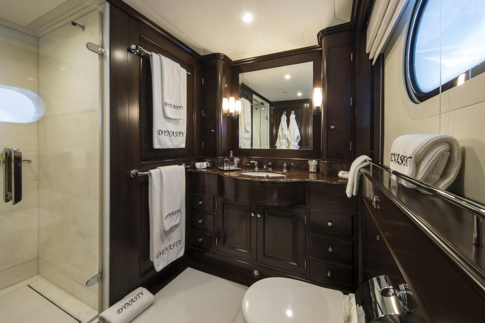 a bathroom with a large mirror aboard DYNASTY Yacht for Sale