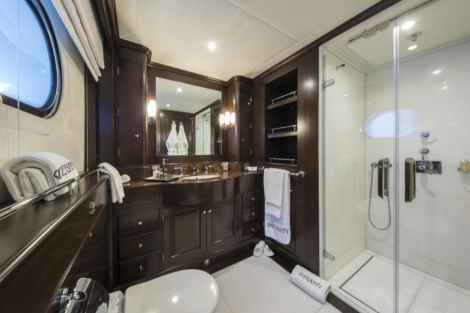 a bathroom with a glass shower aboard DYNASTY Yacht for Sale