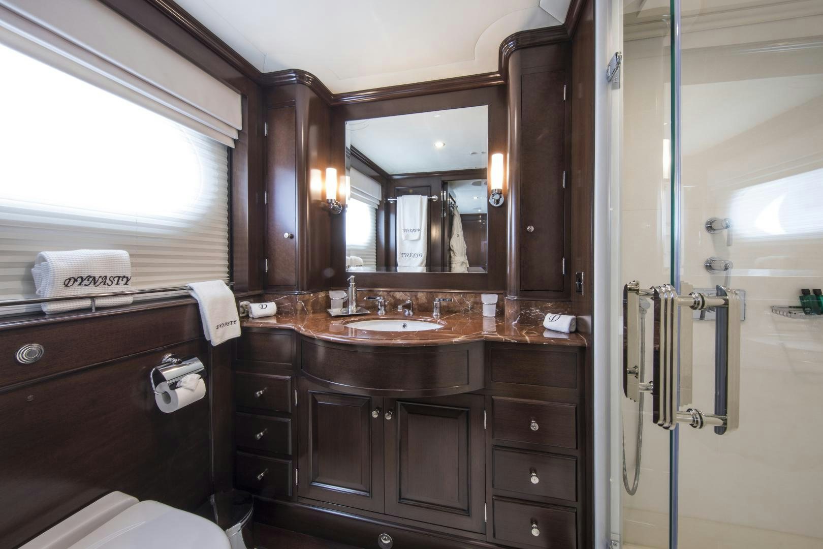 a bathroom with a sink and mirror aboard DYNASTY Yacht for Sale