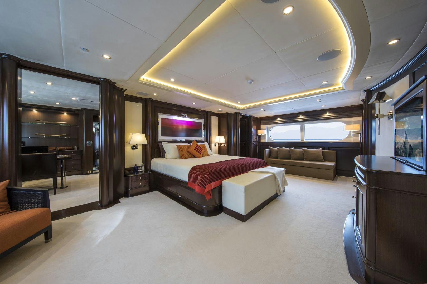 a large hotel room with a bed and a couch aboard DYNASTY Yacht for Sale