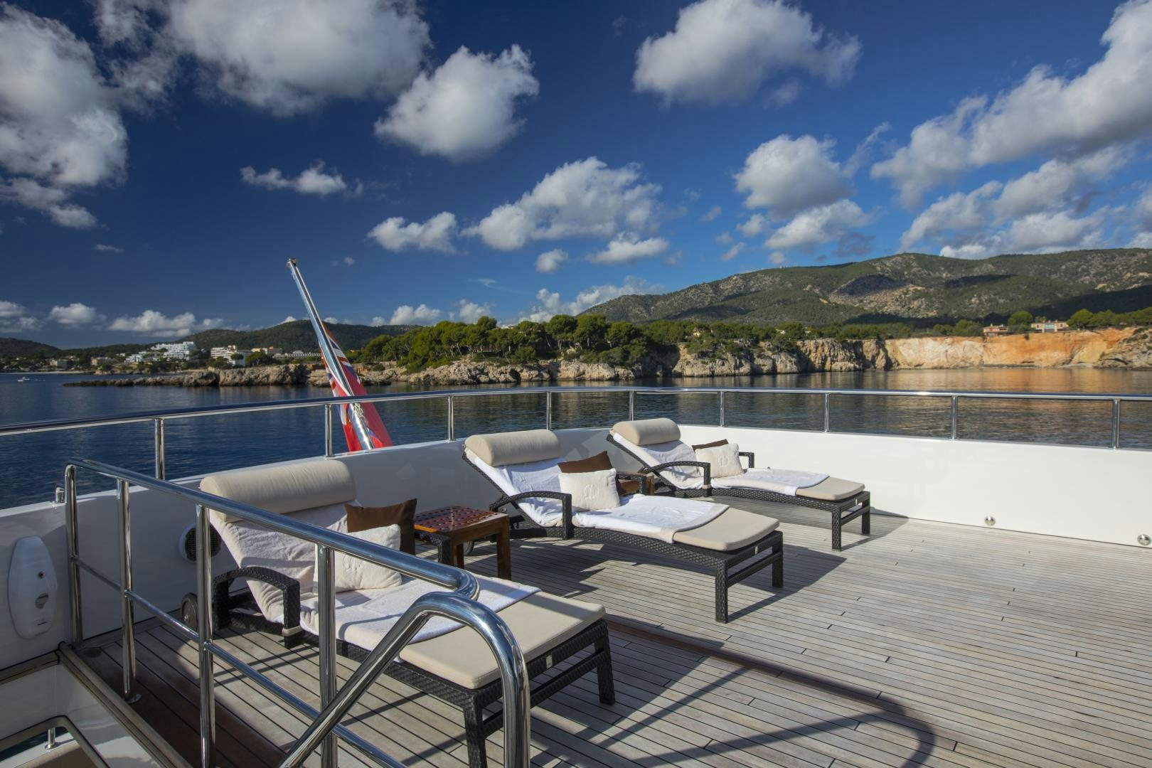 a deck with chairs and a table on it aboard DYNASTY Yacht for Sale