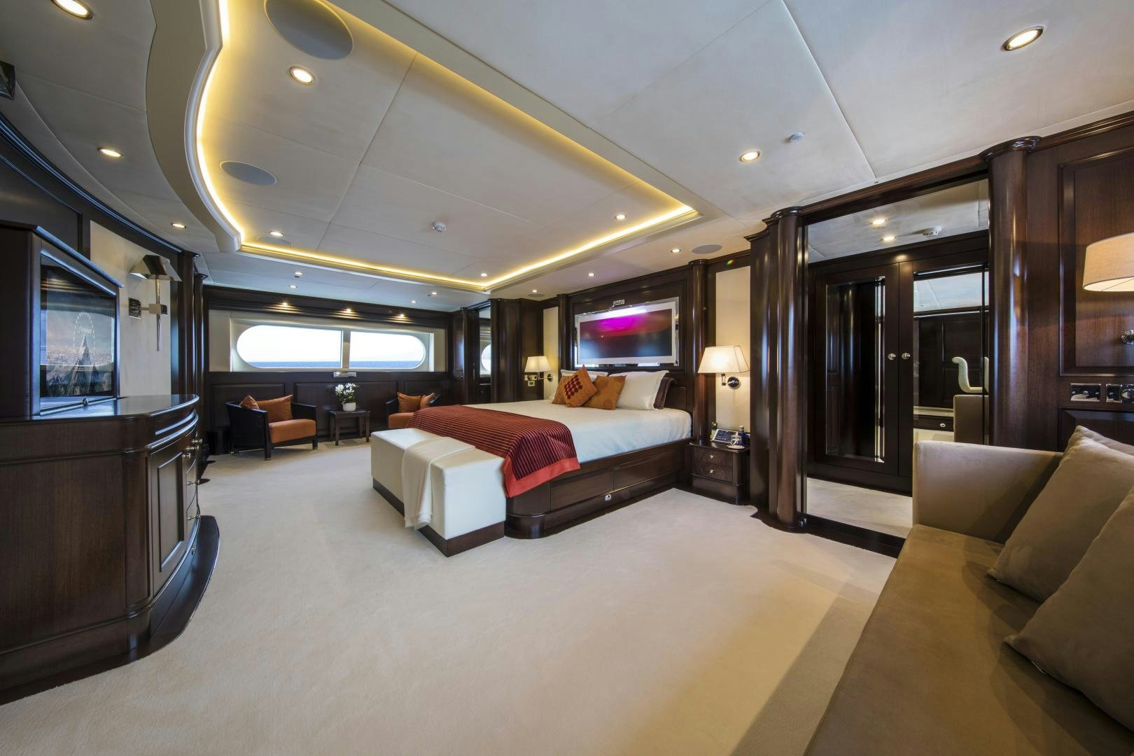 a living room with a large screen aboard DYNASTY Yacht for Sale