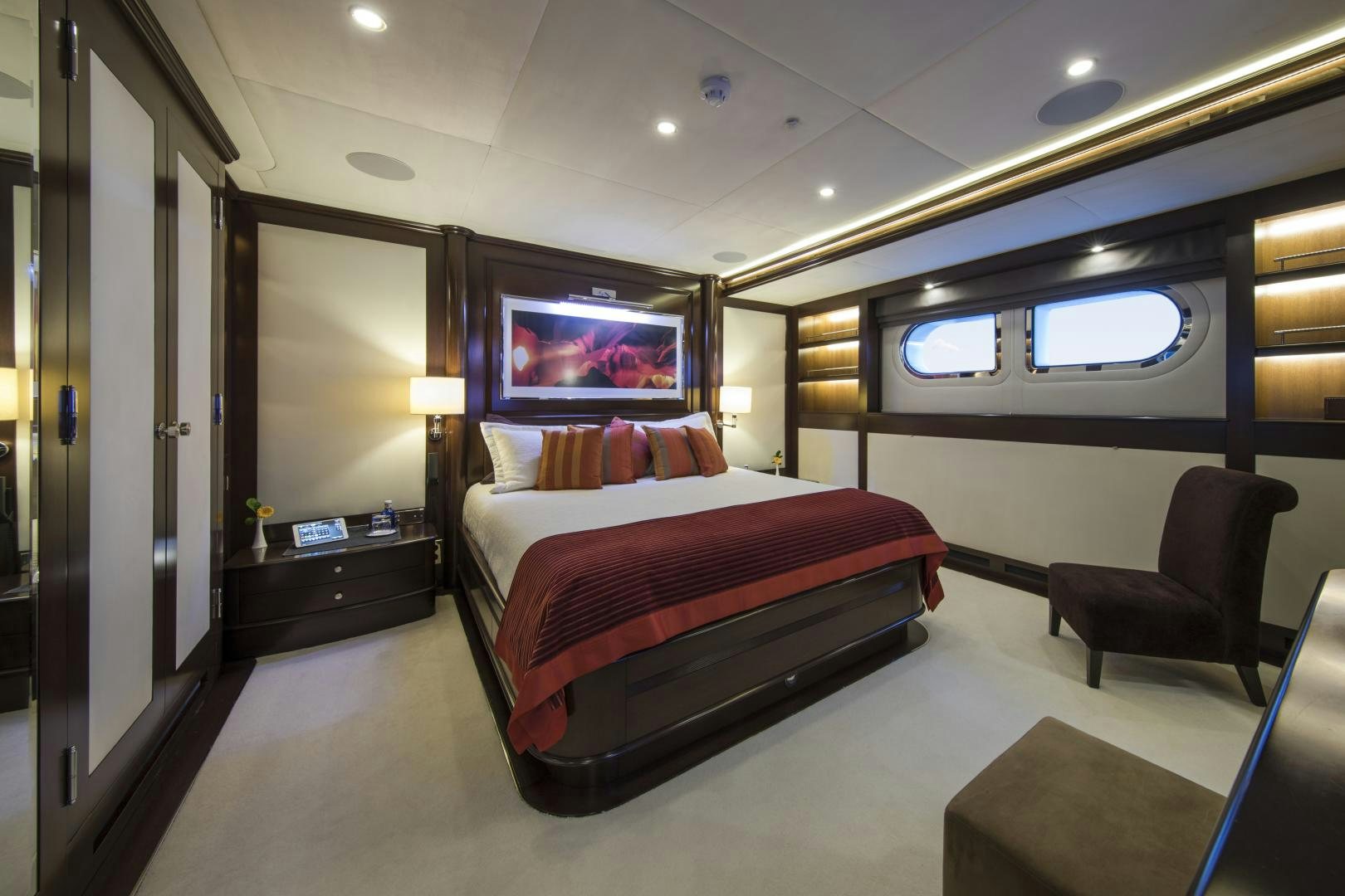 a hotel room with a bed and a tv aboard DYNASTY Yacht for Sale