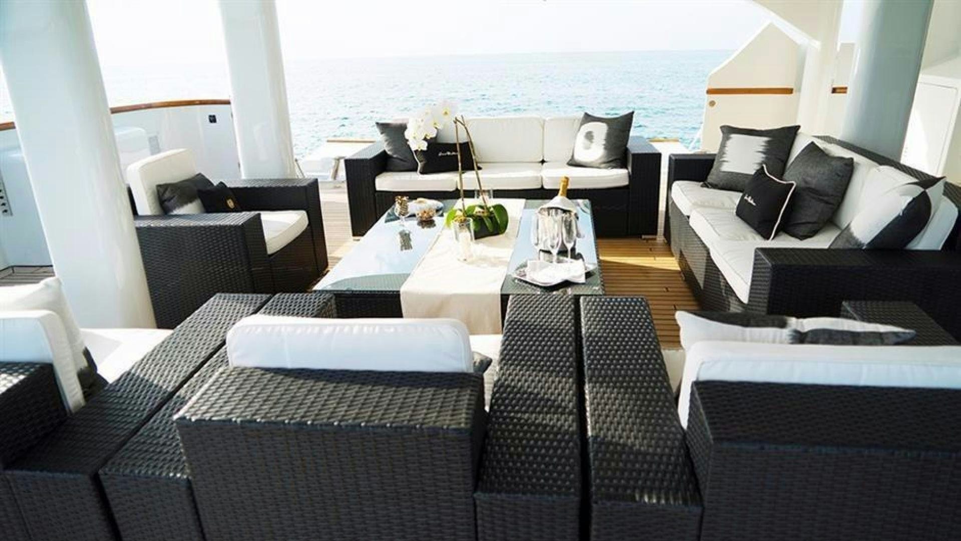 a room with a table and chairs aboard GRAND ILLUSION Yacht for Sale