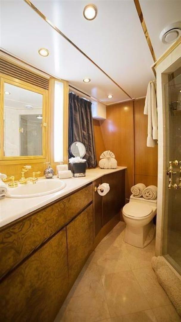 a bathroom with a sink toilet and a mirror aboard GRAND ILLUSION Yacht for Sale