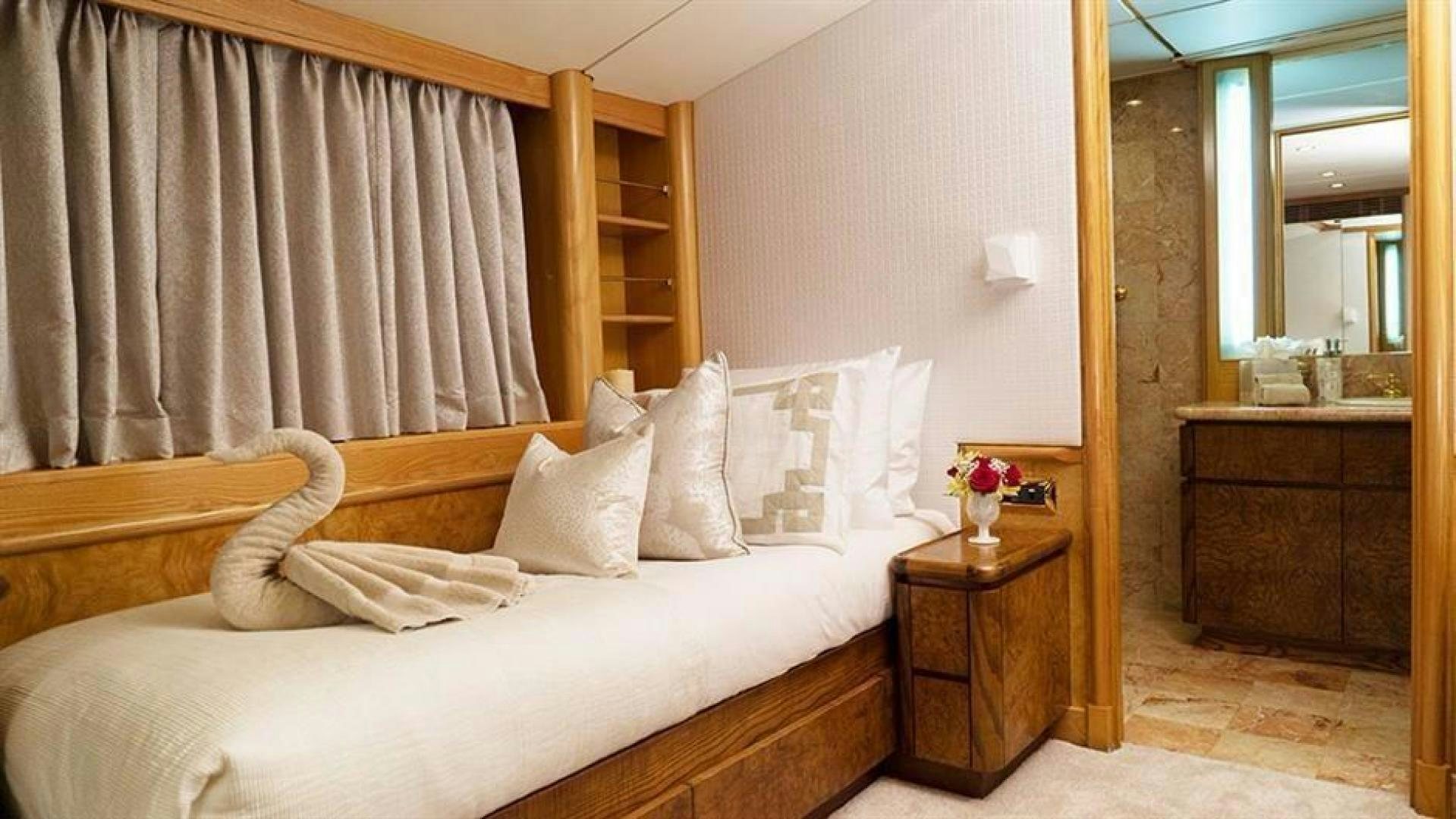 a bed with white sheets aboard GRAND ILLUSION Yacht for Sale