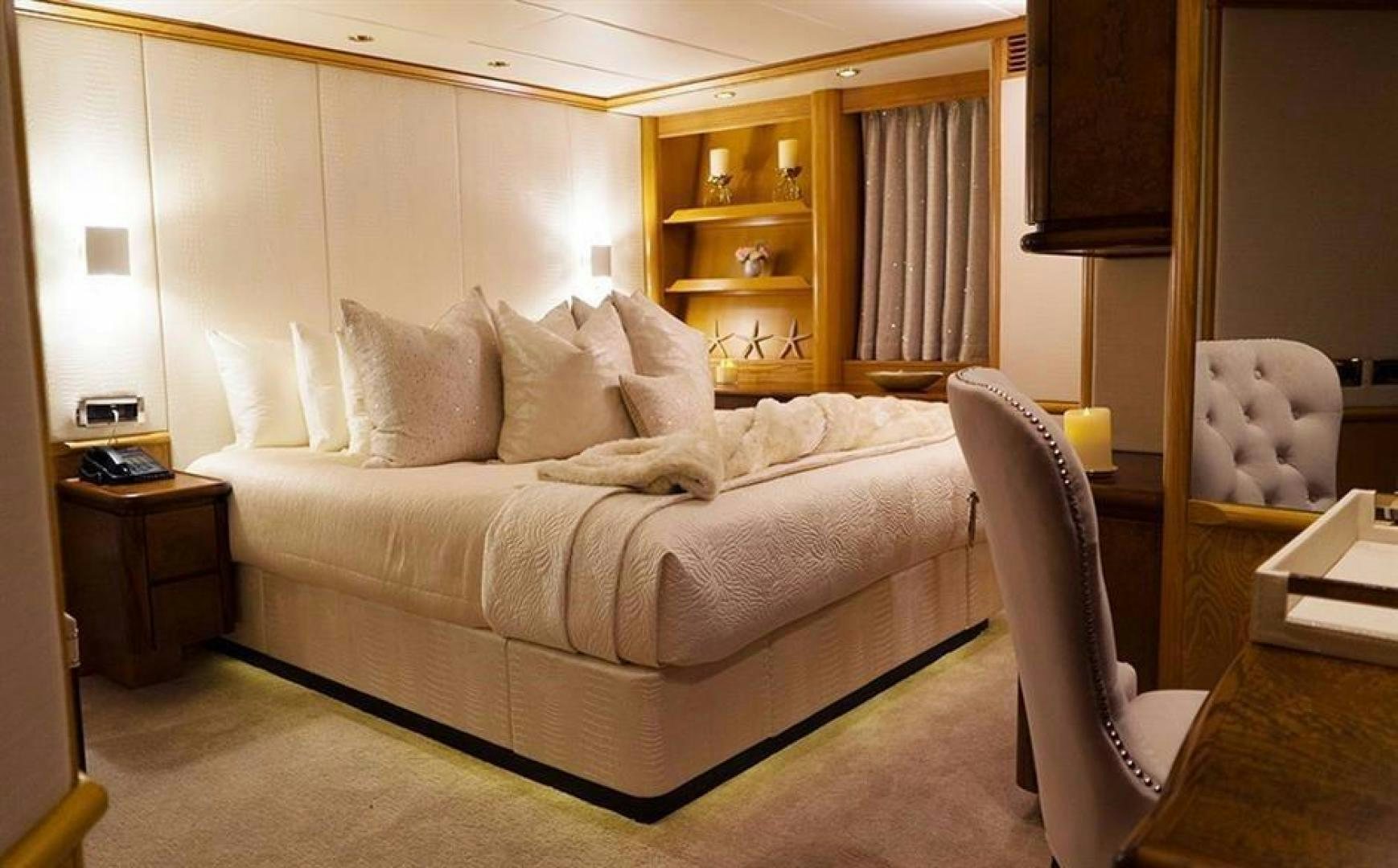 a bed with white sheets aboard GRAND ILLUSION Yacht for Sale