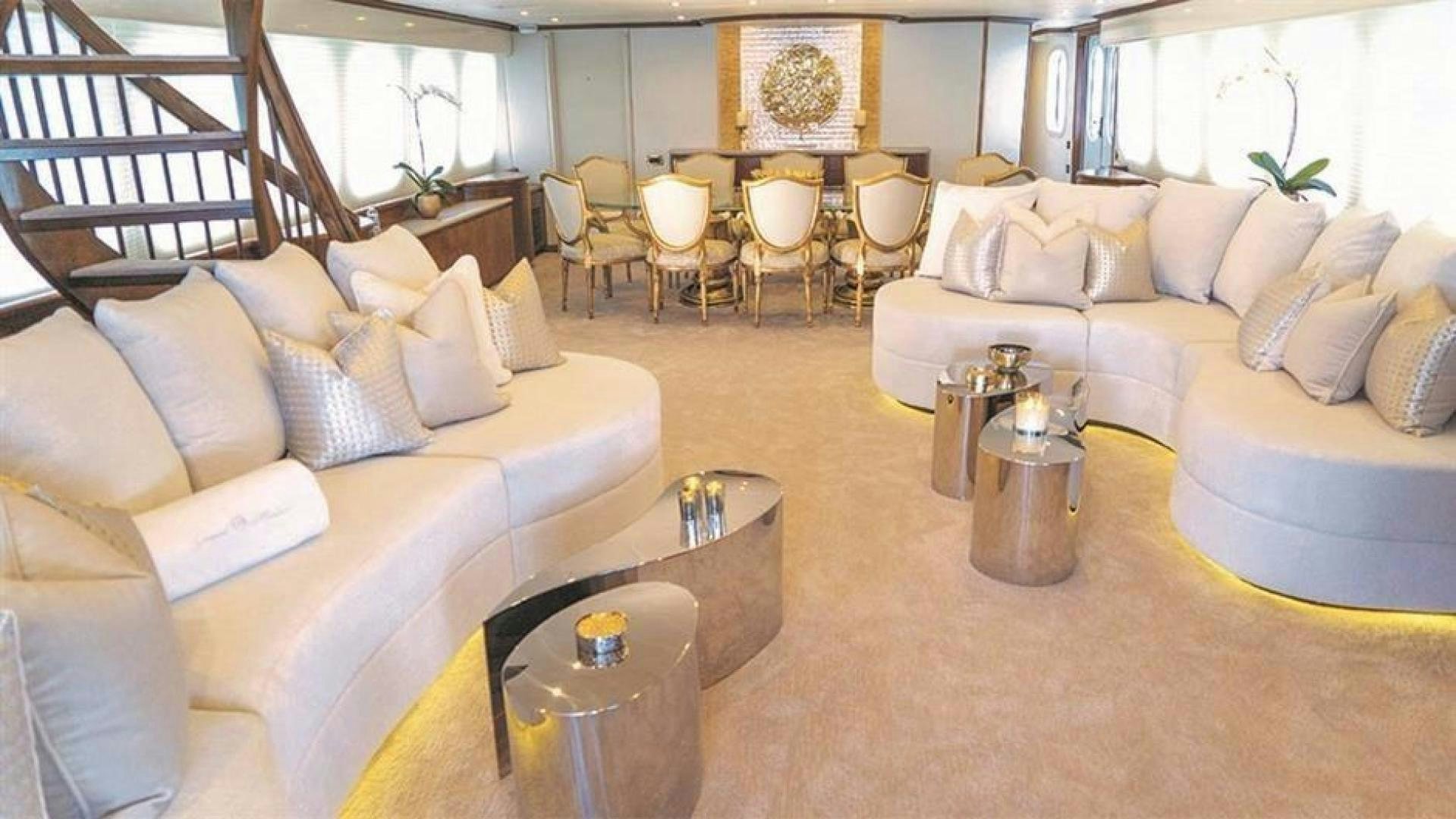 a living room with a couch and a coffee table aboard GRAND ILLUSION Yacht for Sale